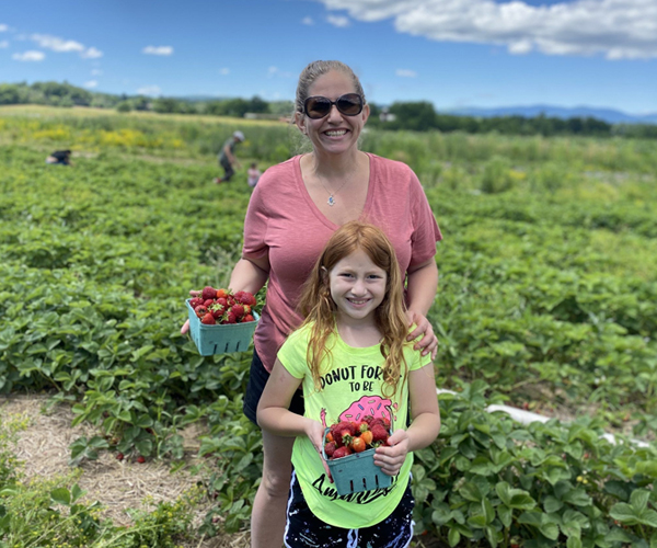 mom & daughter picking berries