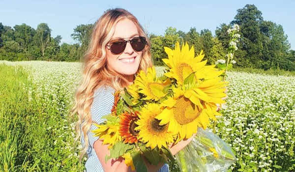 woman with bouquet of sunflowers